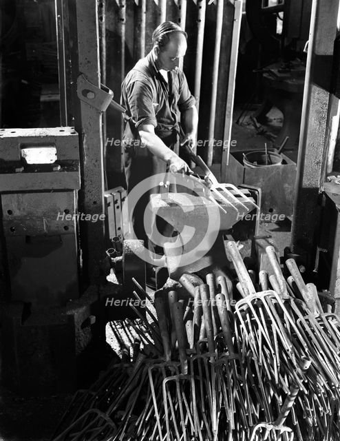 Beating hot garden forks, Ward & Payne Ltd, Sheffield, South Yorkshire, 1965. Creator: Michael Walters.
