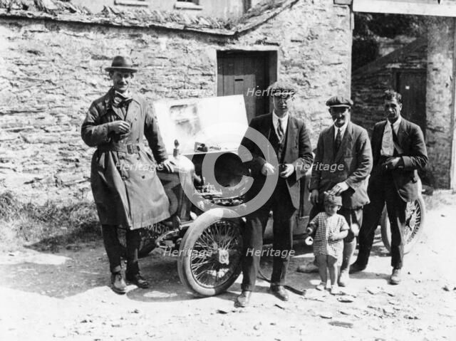 Bedford standing at the front of a car, with onlookers. Artist: Unknown