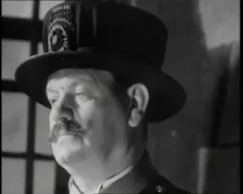 Beefeater guarding the Crown Jewels at the Tower of London, 1937. Creator: British Pathe Ltd