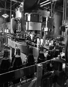 Beer bottles being filled at Ward & Sons, Swinton, South Yorkshire, 1960. Creator: Michael Walters