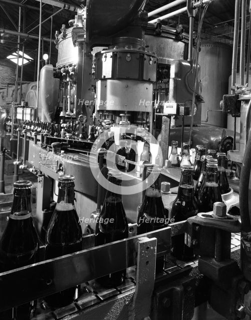 Beer bottles being filled at Ward & Sons, Swinton, South Yorkshire, 1960. Creator: Michael Walters.