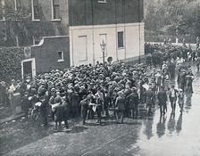 Before England declared war: German Reservists waiting outside German Consulate in London, 1914