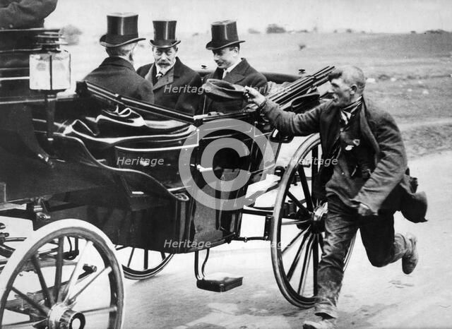 Beggar holidng out his cap as he passes King George V in a carriage, c1911-1936. Artist: Unknown