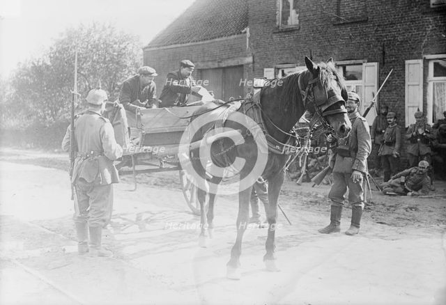 Belgian peasants showing pass to sentries, between 1914 and c1915. Creator: Bain News Service.