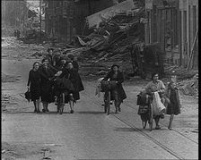 Belgian Refugees Fleeing Their Town Along Bomb Damaged Road, 1940. Creator: British Pathe Ltd