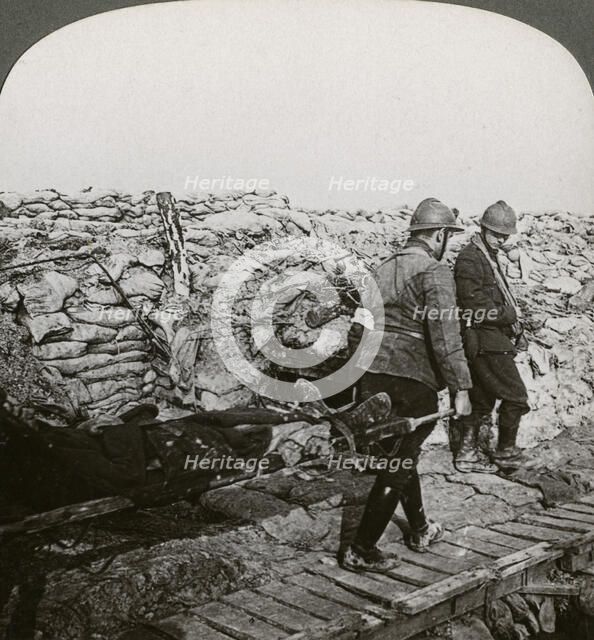 Belgian stretcher bearers carrying wounded in a trench, Dixmude, Belgium, World War I, 1914-1918.Artist: Realistic Travels Publishers