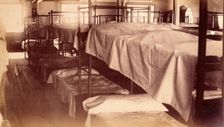 Bellevue Hospital, New York City: a dormitory with bunk beds, 1885-1898. Creator: Unknown