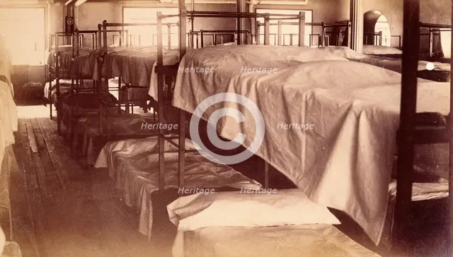 Bellevue Hospital, New York City: a dormitory with bunk beds, 1885-1898. Creator: Unknown.