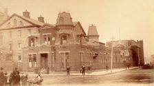 Bellevue Hospital, New York City: a street corner with hospital buildings and people, 1885-1898. Creator: Unknown
