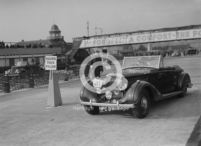 Bentley 4-seater tourer of GG Wood competing in the JCC Rally, Brooklands, Surrey, 1939. Artist: Bill Brunell.