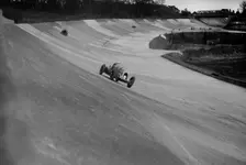 Bentley of Tim Birkin on the way to winning a race at a BARC meeting, Brooklands, 1930. Artist: Bill Brunell