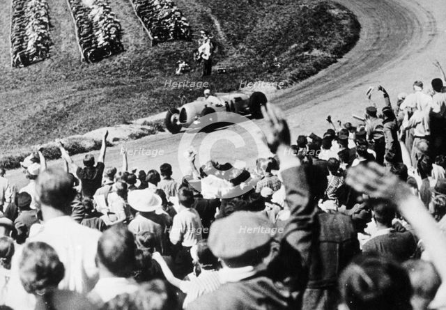 Bernd Rosemeyer acclaimed by the crowd, German Grand Prix, Nurburgring, 1936. Artist: Unknown