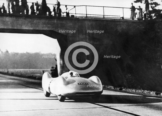 Bernd Rosemeyer driving an Auto Union, c1937-c1938. Artist: Unknown