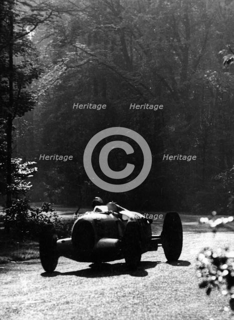 Bernd Rosemeyer driving an Auto Union, Donington Grand Prix, 1937. Artist: Unknown
