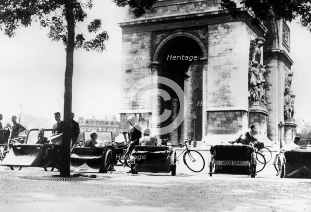 Bicycle taxis in the Place d'Etoile by the Arc de Triomphe, German-occupied Paris, August 1943. Artist: Unknown