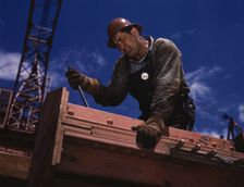 Big Pete Ramagos, rigger at work on dam (TVA) Douglas Dam, Tenn., 1942. Creator: Alfred T Palmer