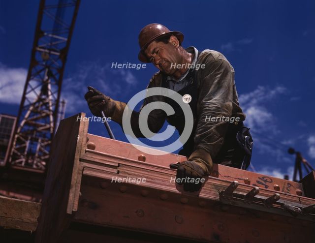 Big Pete Ramagos, rigger at work on dam (TVA) Douglas Dam, Tenn., 1942. Creator: Alfred T Palmer.