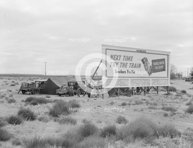 Billboard along U.S. 99...three destitute families...Kern County, CA, 1938. Creator: Dorothea Lange.