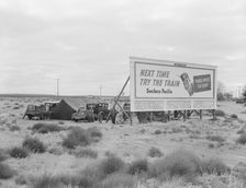 Billboard along U.S. 99...three destitute families...Kern County, CA, 1938. Creator: Dorothea Lange