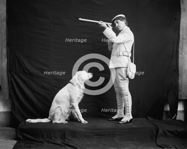Billy and his mistress in hunting poses, between 1895 and 1910. Creator: Unknown.