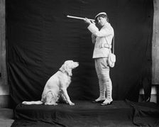 Billy and his mistress in hunting poses, between 1895 and 1910. Creator: Unknown