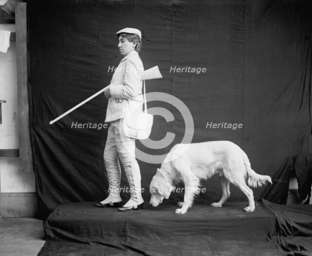 Billy and his mistress in hunting poses, between 1895 and 1910. Creator: Unknown.