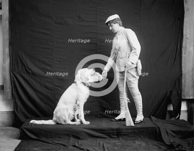 Billy and his mistress in hunting poses, between 1895 and 1910. Creator: Unknown.