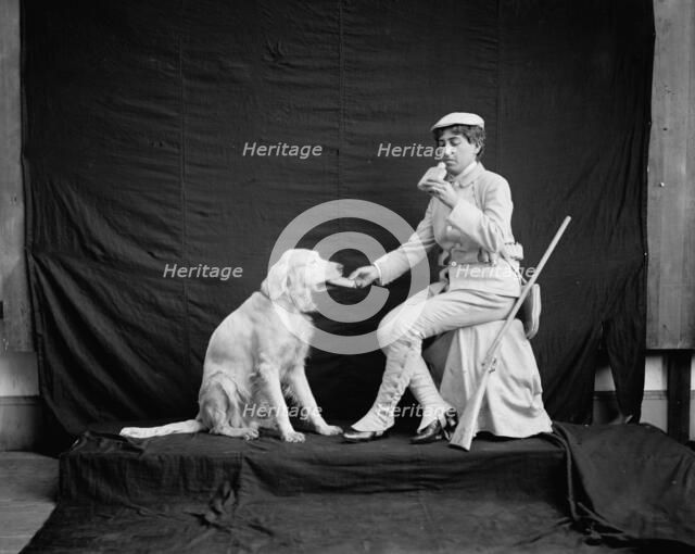 Billy and his mistress in hunting poses, between 1895 and 1910. Creator: Unknown.