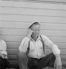 Bindle stiff, used to be logger, Side of Pastime Café, Tulelake, Siskiyou County, California, 1939. Creator: Dorothea Lange