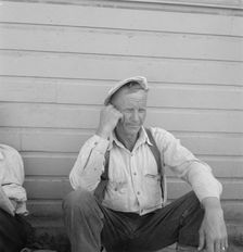 Bindle stiff, used to be logger, Side of Pastime Café, Tulelake, Siskiyou County, California, 1939. Creator: Dorothea Lange