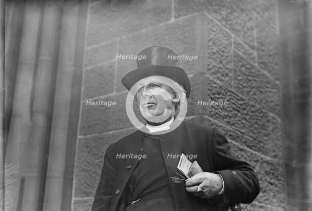 Bishop of Salisbury holding glasses and train schedule, 1910. Creator: Bain News Service.