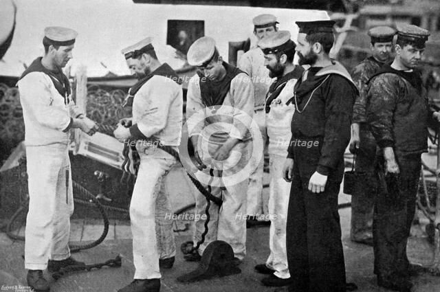 Blue jackets at work splicing a rope on board the battleship HMS 'Majestic', 1896.Artist: Gregory & Co