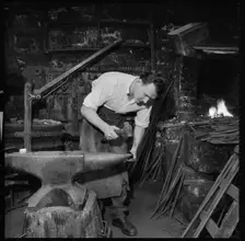 Blacksmith working at an anvil, 1967. Creator: Eileen Deste