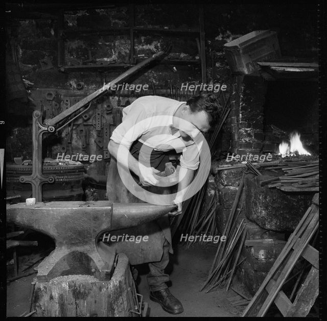 Blacksmith working at an anvil, 1967. Creator: Eileen Deste.