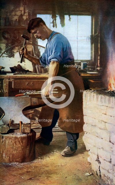 Blacksmith at work, England, c1922. Artist: Sidney H Nicholls
