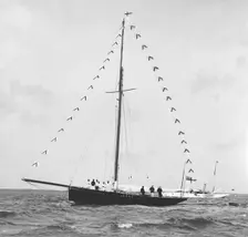 Bloodhound at anchor with prize flags, 1909. Creator: Kirk & Sons of Cowes