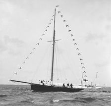 Bloodhound at anchor with prize flags, 1909. Creator: Kirk & Sons of Cowes