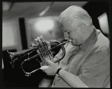 Bruce Adams playing the flugelhorn at The Fairway, Welwyn Garden City, Hertfordshire, 2 June 2002. Creator: Denis Williams