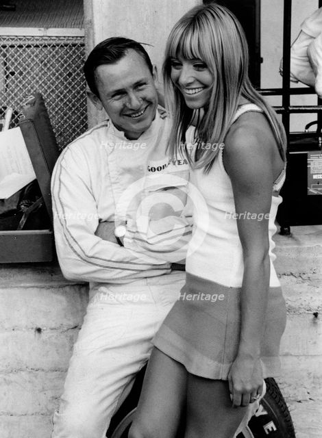 Bruce McLaren with female admirer in the pits, 1967 Italian Grand Prix. Creator: Unknown.