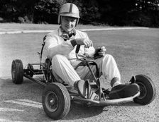 Bruce McLaren on his Em-Bee Wasp kart. Creator: Unknown