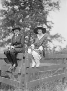 Bruce, Mrs., and Miss Hedman, seated outdoors on a fence, 1919 May 30. Creator: Arnold Genthe
