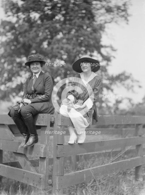 Bruce, Mrs., and Miss Hedman, seated outdoors on a fence, 1919 May 30. Creator: Arnold Genthe.