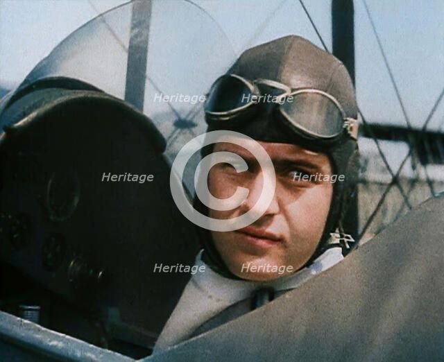 Bruno Mussolini, Son of Italian Leader Benito Mussolini, in Flying Cap Sitting in the..., 1937. Creator: British Pathe Ltd.