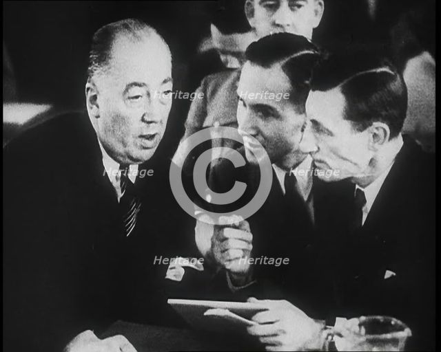 Bruno Richard Hauptmann Talking To His Attorney Edward J. Reilly in a Courtroom During His..., 1930s Creator: British Pathe Ltd.