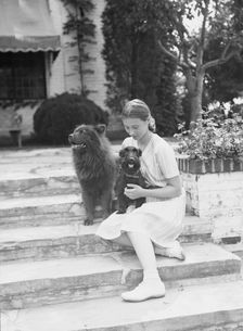 Brady, Genevieve, Miss, with dogs, seated outdoors, between 1931 and 1934. Creator: Arnold Genthe