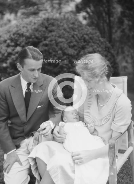 Brady, James Cox, Jr., Mr. and Mrs., and child, seated outdoors, 1930 May 24. Creator: Arnold Genthe.