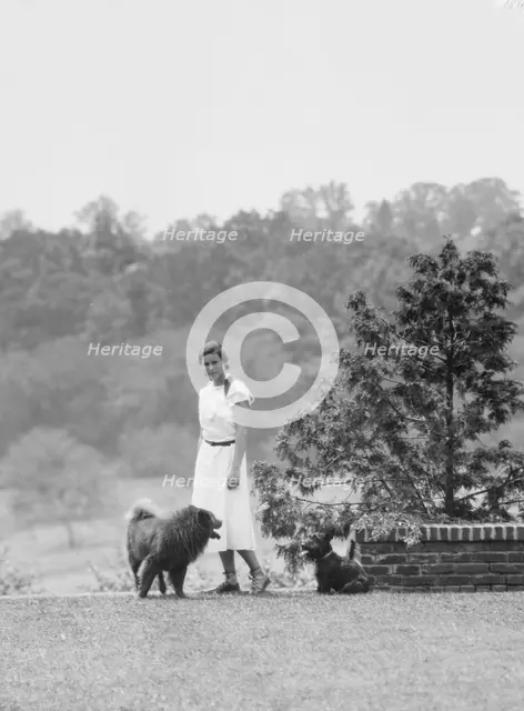 Brady, Victoria, Miss, with dogs, standing outdoors, 1931 July 14. Creator: Arnold Genthe.