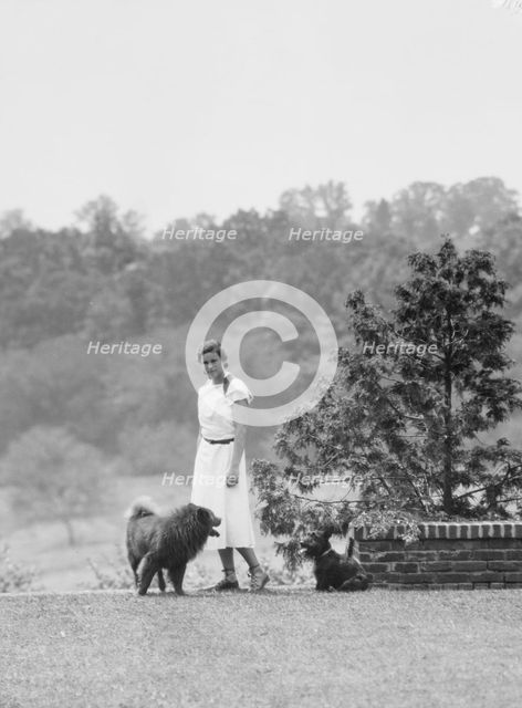 Brady, Victoria, Miss, with dogs, standing outdoors, 1931 July 14. Creator: Arnold Genthe.