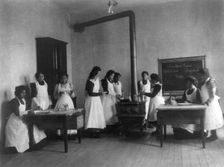 Breakfast lesson in home economics class for women. Carlisle Indian School, Pa., 1901. Creator: Frances Benjamin Johnston