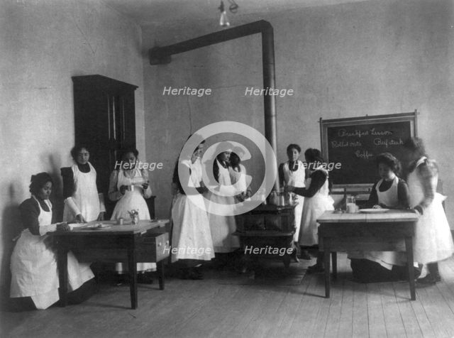 Breakfast lesson in home economics class for women. Carlisle Indian School, Pa., 1901. Creator: Frances Benjamin Johnston.